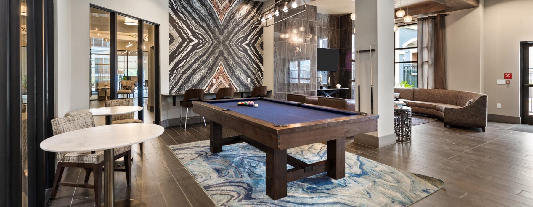 Spacious game room with wood floors and a large billiards table