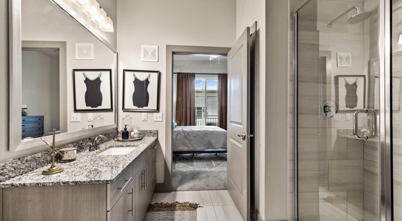 bathroom with a large mirror and ample lighting